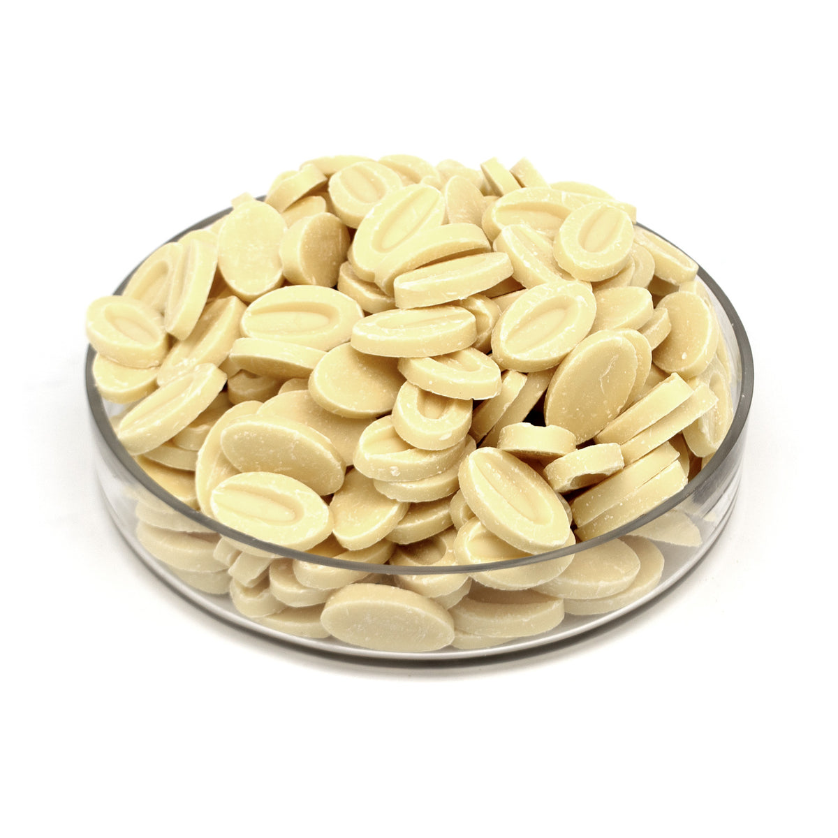 A clear glass bowl filled with small, oval-shaped, pale cream-colored chocolate feves, photographed on a seamless white background.
