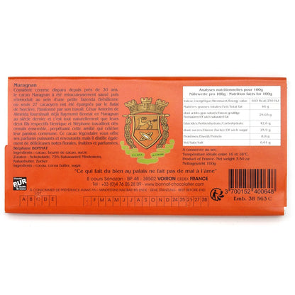 Back of a chocolate bar packaging with branding and text on an orange background