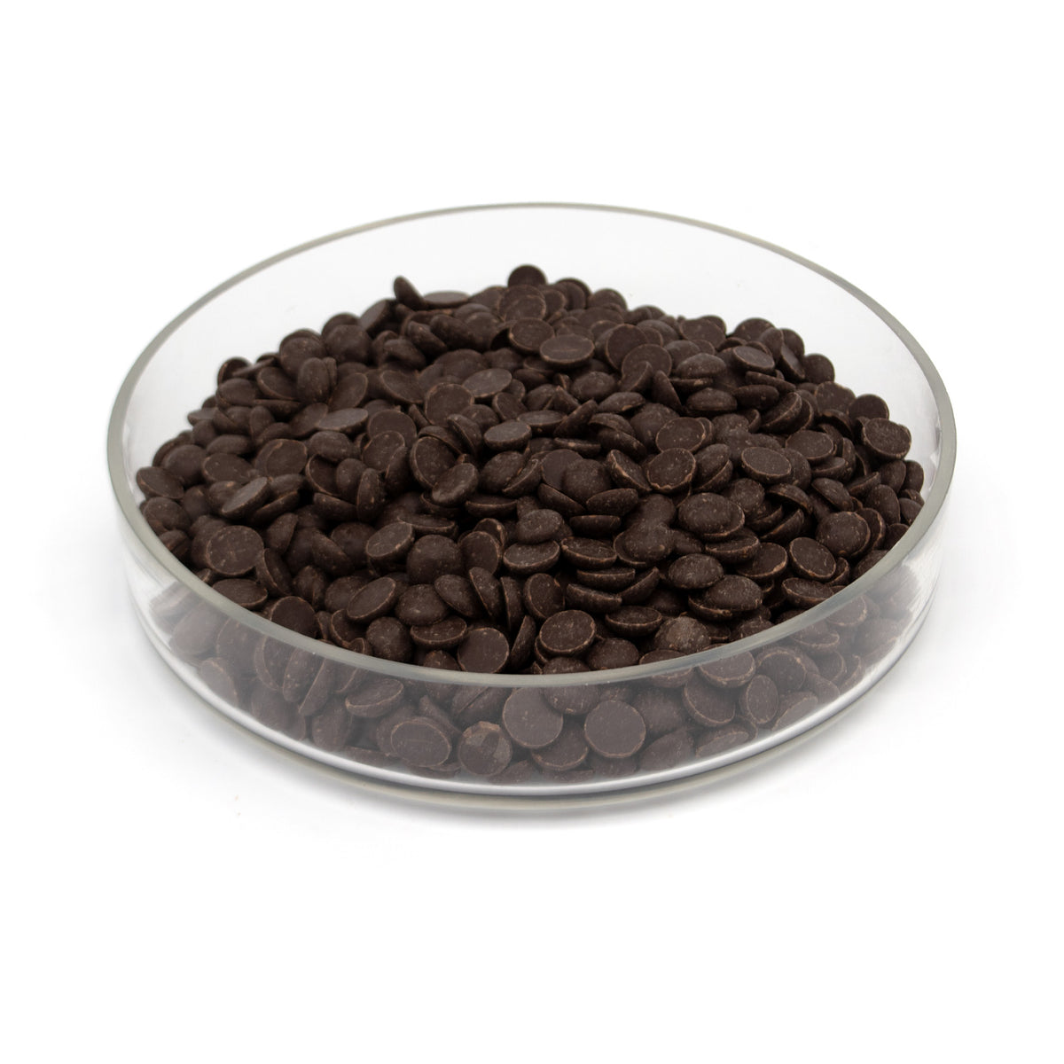 Dark brown chocolate chips piled in a clear glass bowl on a white background.