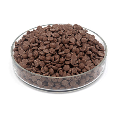 Glass bowl filled with chocolate chips on a white background