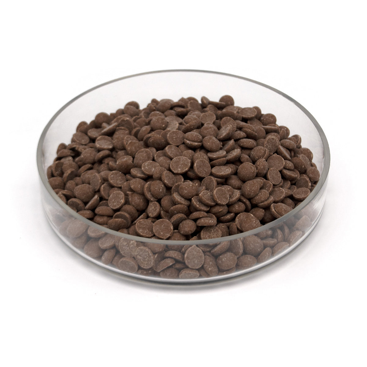 Brown chocolate chips piled in a clear glass bowl on a white background.
