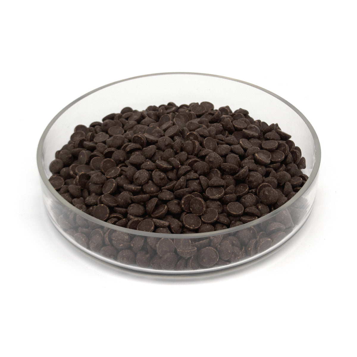 Dark brown chocolate chips piled in a clear glass bowl on a white background.