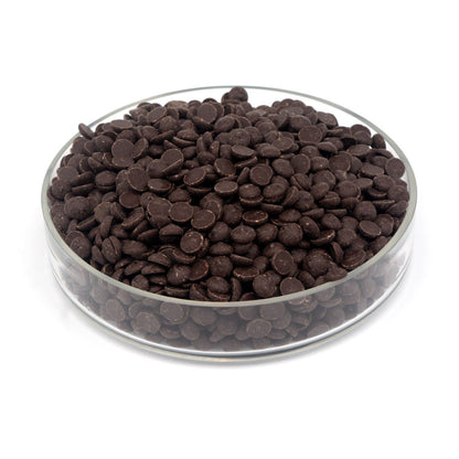 Glass bowl filled with dark chocolate chips on a white background