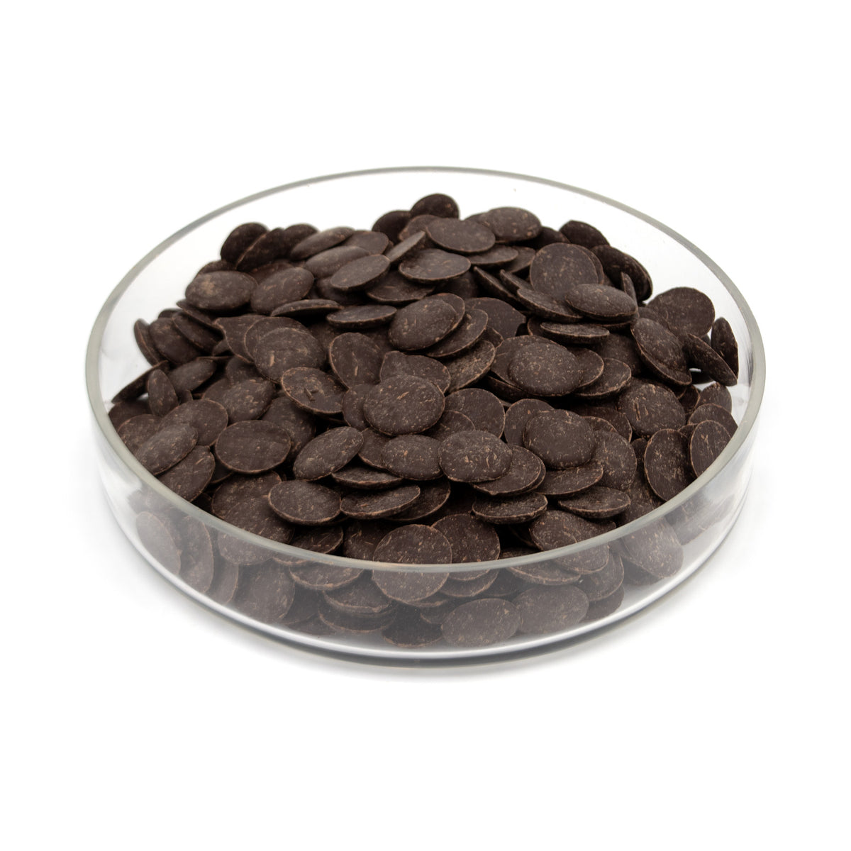 A pile of dark brown chocolate wafers in a clear round glass container, photographed on a white background.