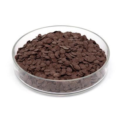 Glass bowl filled with chocolate chips on a white background