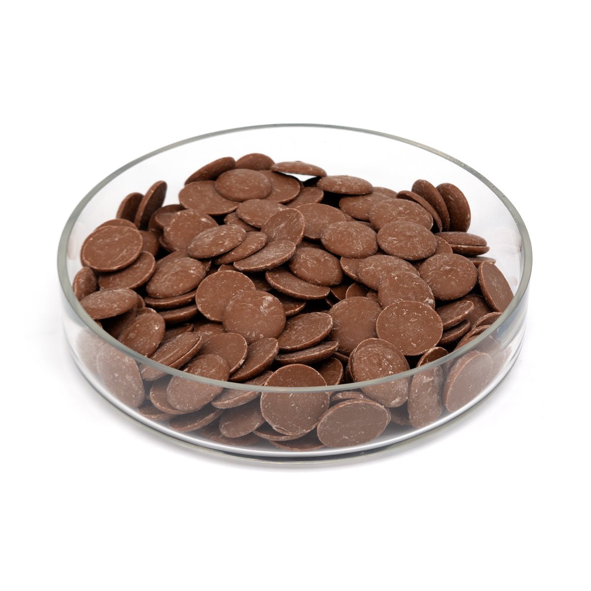 Glass bowl filled with chocolate discs on a white background