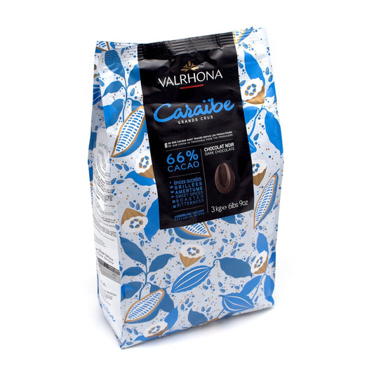 A 3 kg bag of Valrhona Caraïbe chocolate, featuring a white bag decorated with blue and gold cocoa pod illustrations and a black central label.