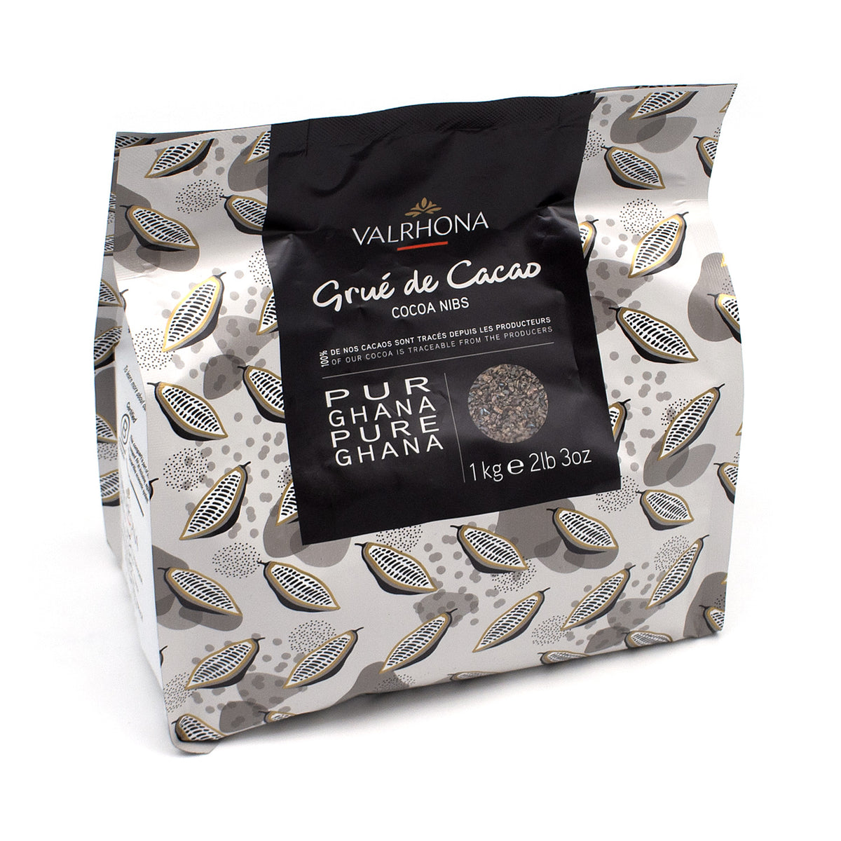 A 1 kg (2.2 lb) bag of Valrhona Grúe de Cacao Cocoa Nibs from Ghana, featuring a black central label on a gray and white patterned background.