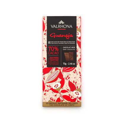 Valrhona Guanaja dark chocolate bar packaging with red and beige design on a white background