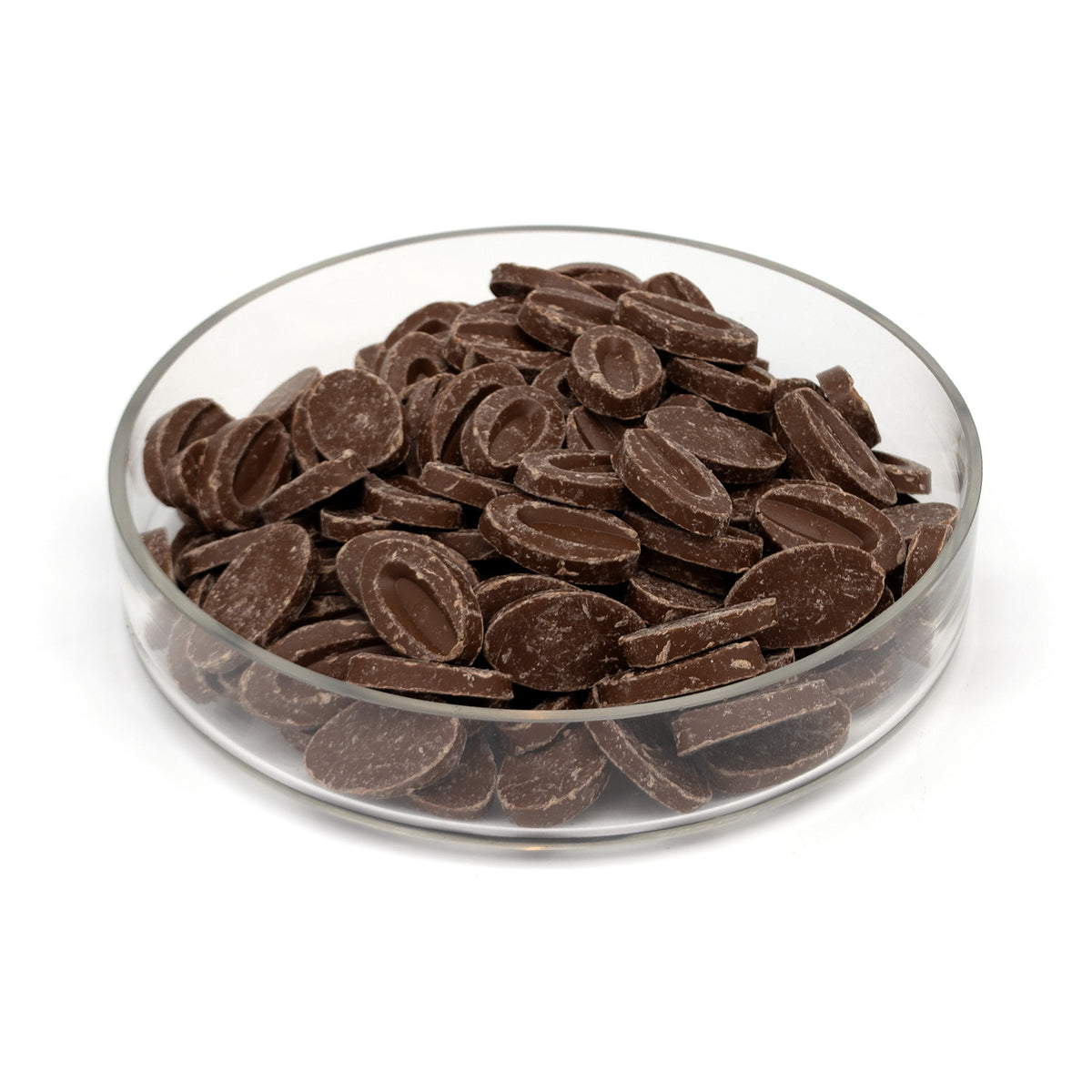 Chocolate feves in a clear glass bowl, photographed on a clean white background.