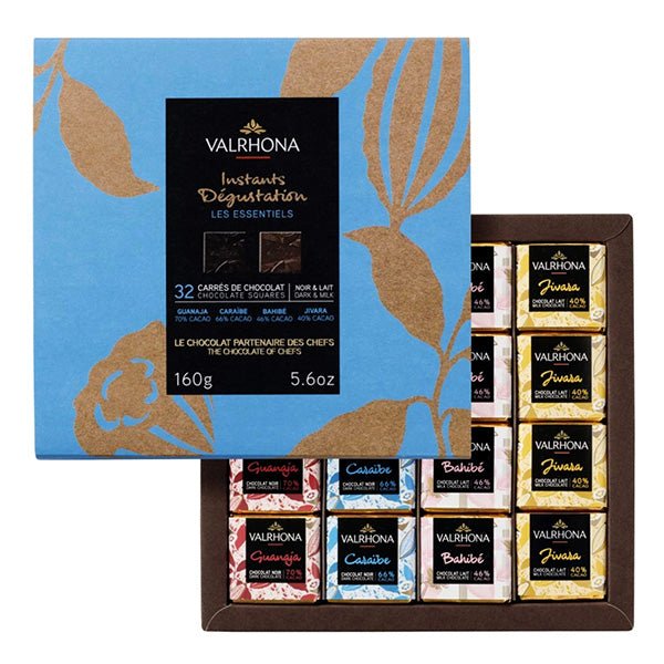 Valrhona chocolate assortment with a blue and brown decorative box on a white background