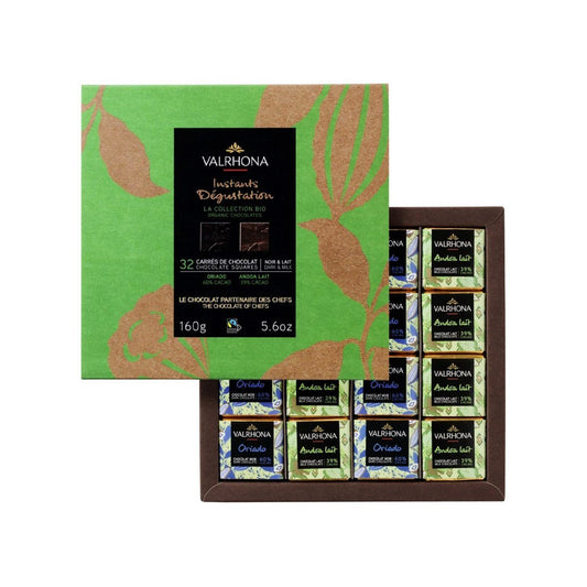 Valrhona chocolate assortment in a green and brown box on a white background